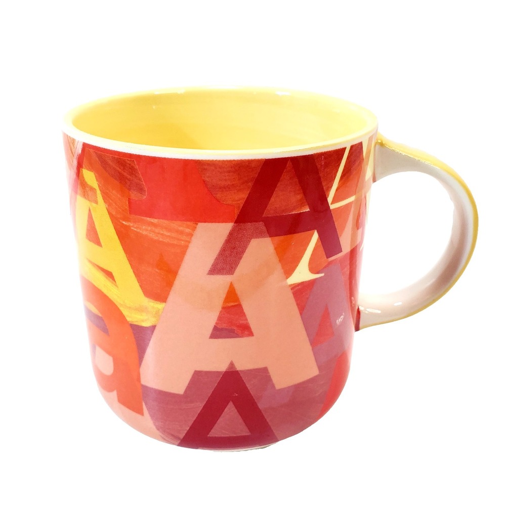 Anthropologie Coffee Mug Cup Multicolored A's in Different Fonts Yellow Inside